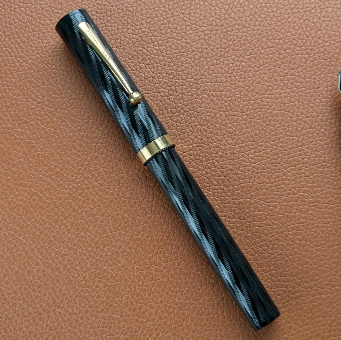 Sheaffer Old Timer. The spiral chasing pattern is referred to as torsade from what I've seen, but I don't know that to be the official designation.